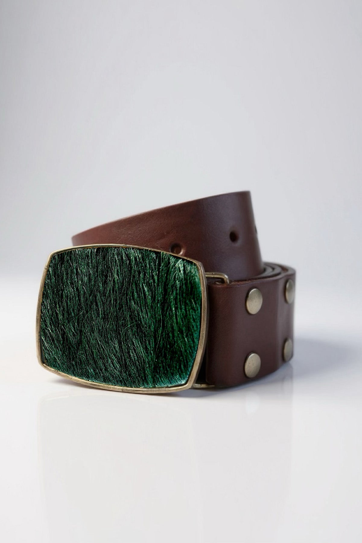 Brown leather belt with a green buckle on a white background