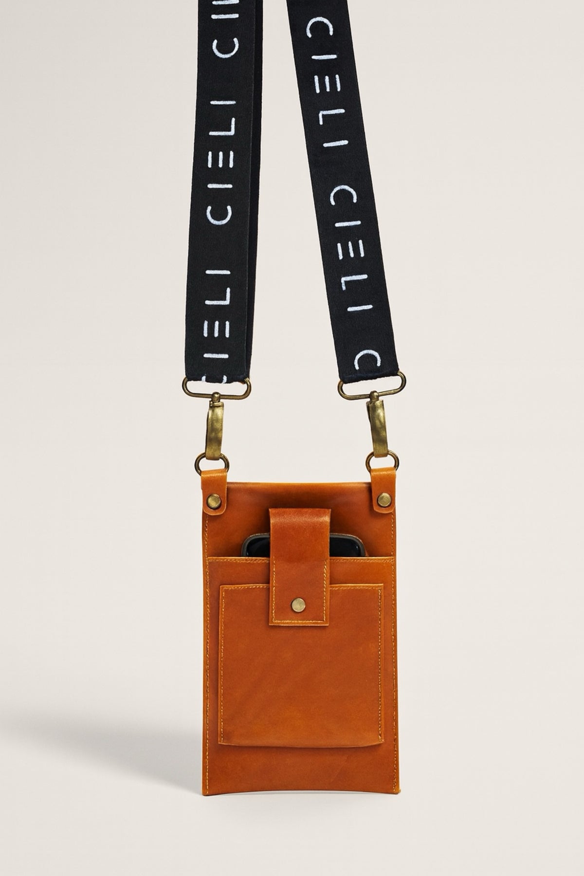 Close up of signature sling bag in brown