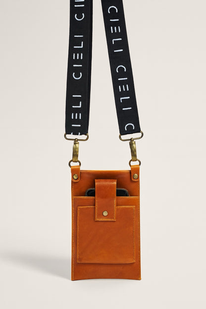 Close up of signature sling bag in brown