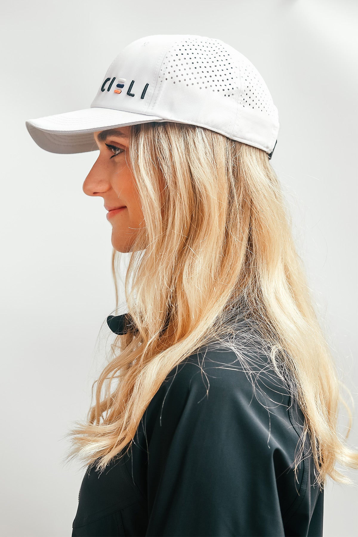 Side profile of the Cieli Signature Cap showing curved brim and lightweight design.